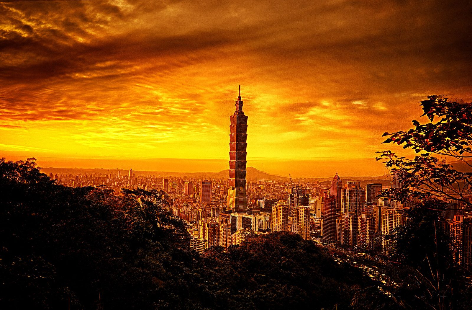 Taipei skyline at dusk, with office towers above the river basin where long-term capital is allocated and monitored.
